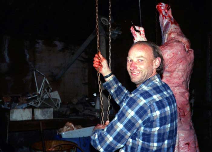 Robert Pickton, the Pig Farm Killer, with a hog. He killed women and strung them up in the same hooks
