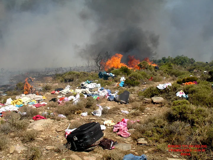 Passenger baggage lay strewn across the burning chaparral. (EMAK)