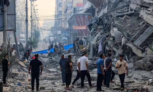 People in Gaza City after an Israeli airstrike early on Sunday. Photograph by Mahmud Hams